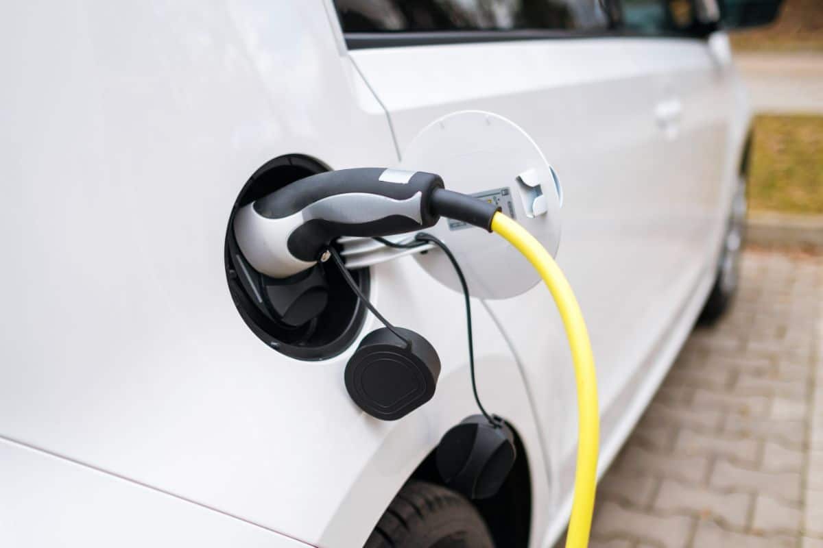 a-white-electric-car-charging-at-the-charging-stat-2021-09-27-19-03-21-utc (1)